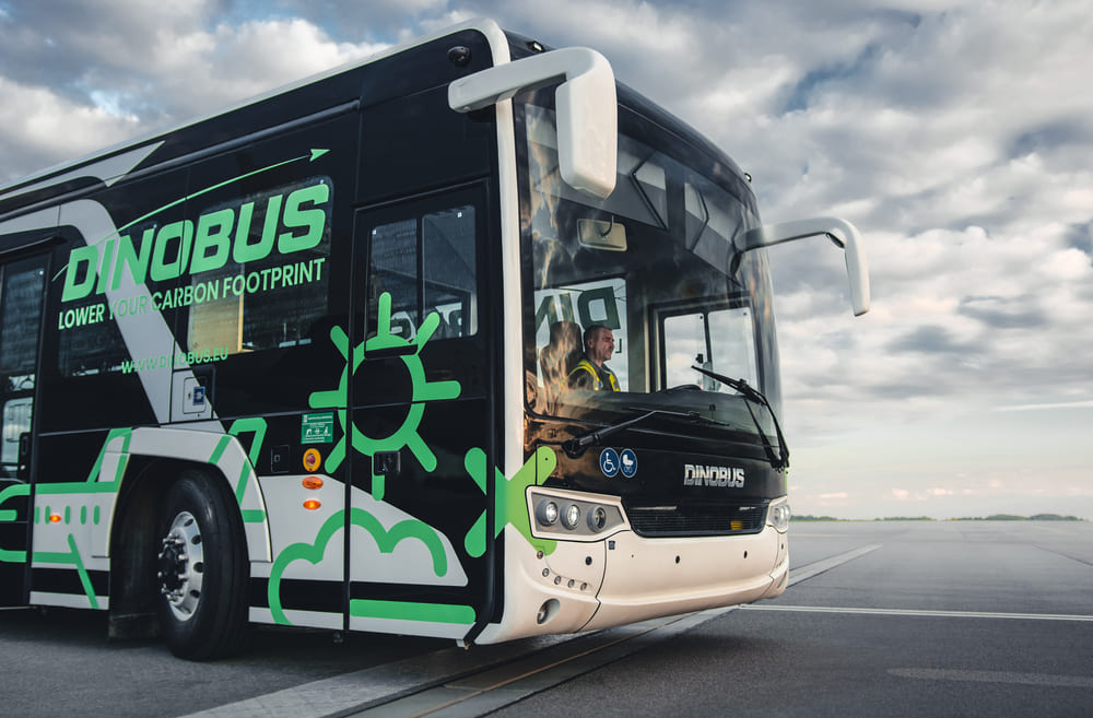 Side view of white apron bus